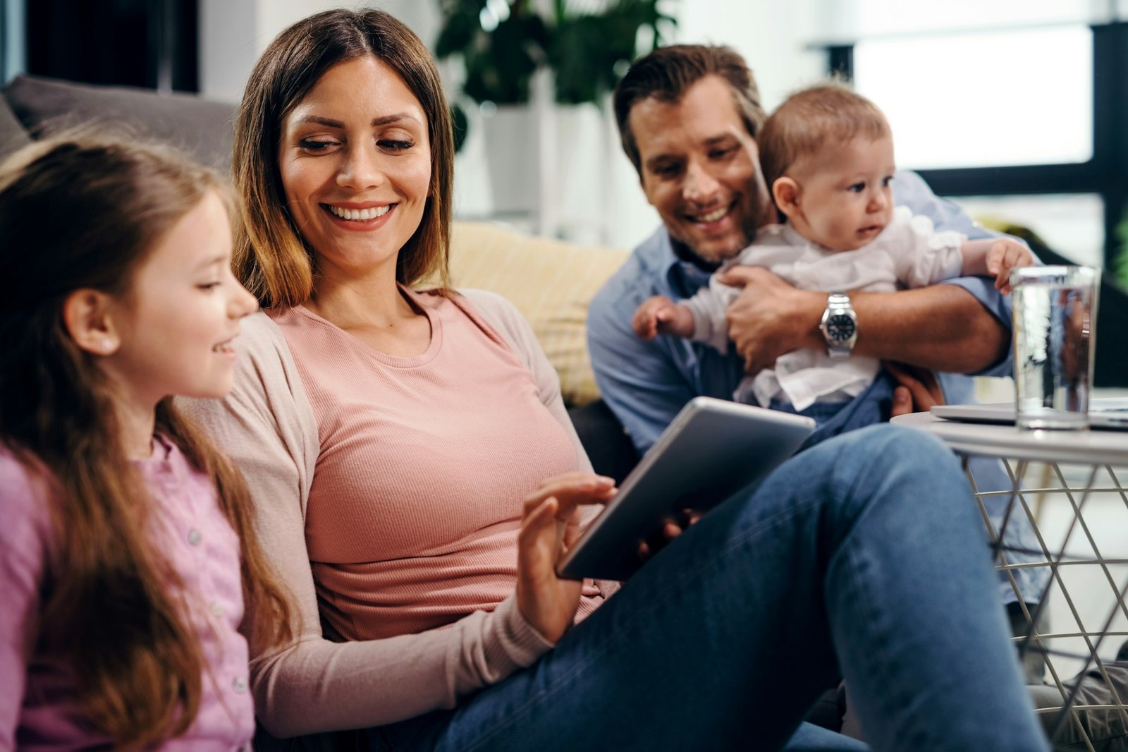 Happy family using touchpad in the living room.